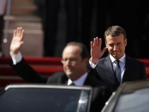 French outgoing President Francois Hollande (L) is escorted by his successor Emmanuel Macron (R) as he leaves the Elysee presidential Palace at the end of their handover ceremony and prior to Macron's formal inauguration as French President on May 14, 2017 in Paris. / AFP PHOTO / POOL / YOAN VALAT